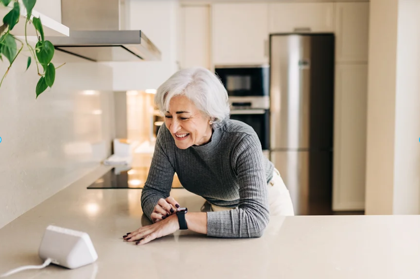 Senior woman using a smart watch and smart speaker