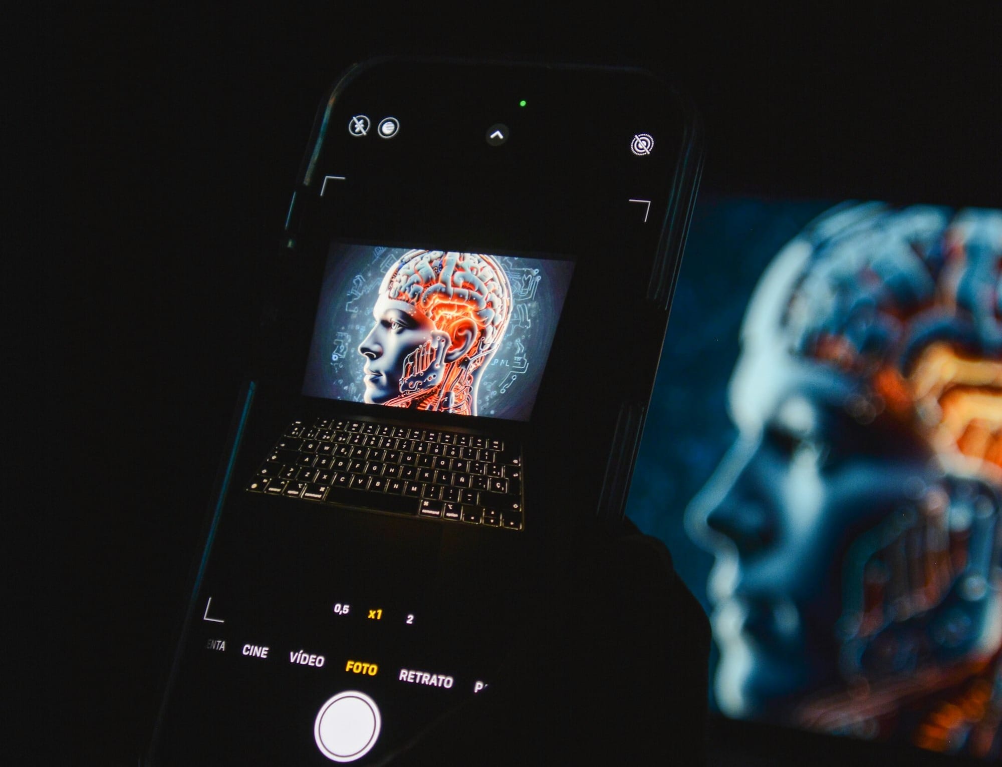 a cell phone sitting on top of a laptop computer